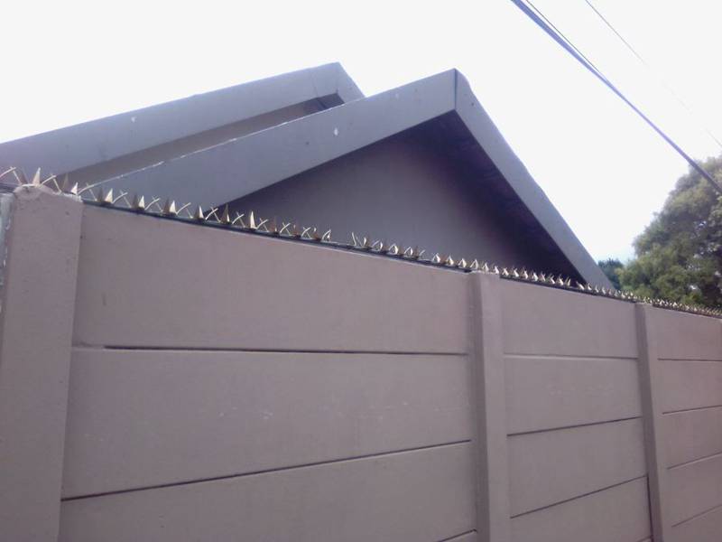 Shark tooth wall spikes fitted on top of a precast boundary wall
