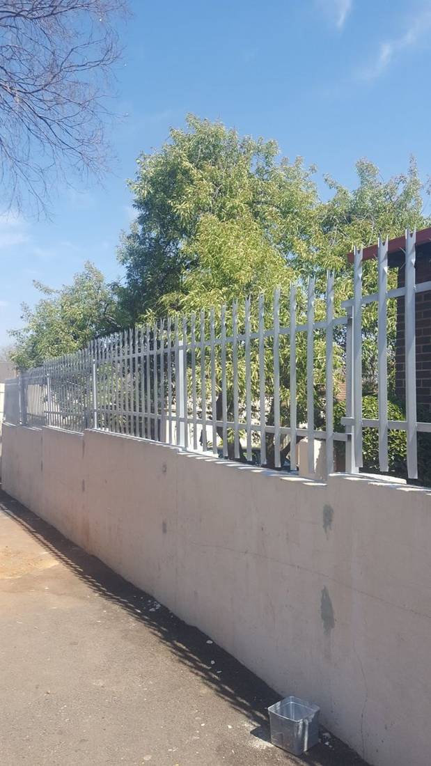 Palisade fencing supplied and installed on a boundary wall